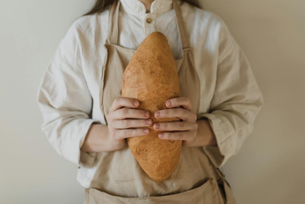 Close Up Photo of a Person Holding Bread